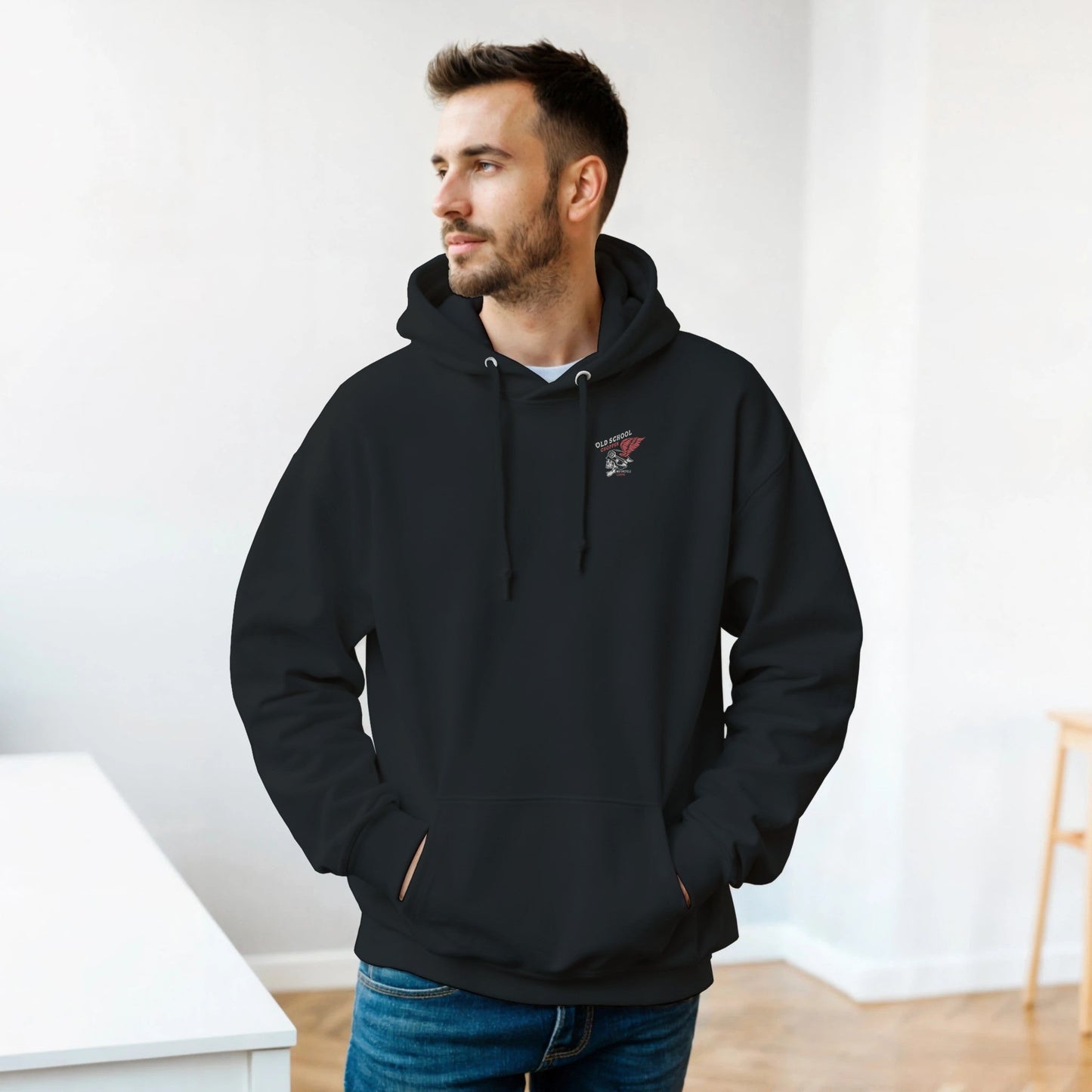 man wearing black rocker biker hoodie with double-lined hood and front pocket indoors