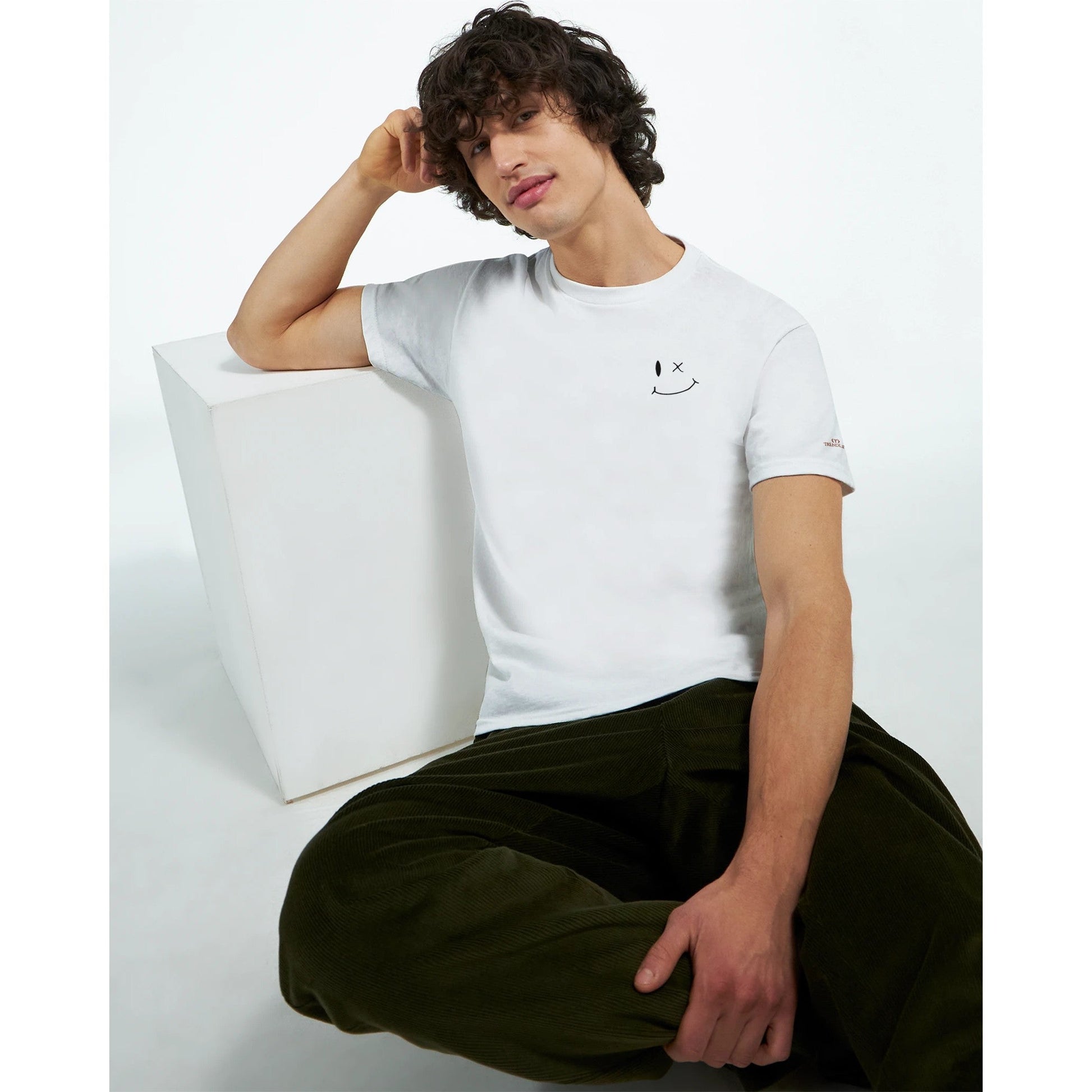 Mann trägt weißes Stickerei Smile Unisex T-Shirt aus schwerer Baumwolle mit lässigem Stil und klassischer Passform
