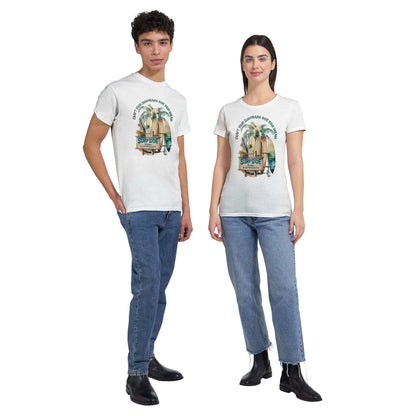 Models wearing white Sommer Surfside T-Shirt with beach and surf graphic, paired with jeans and boots
