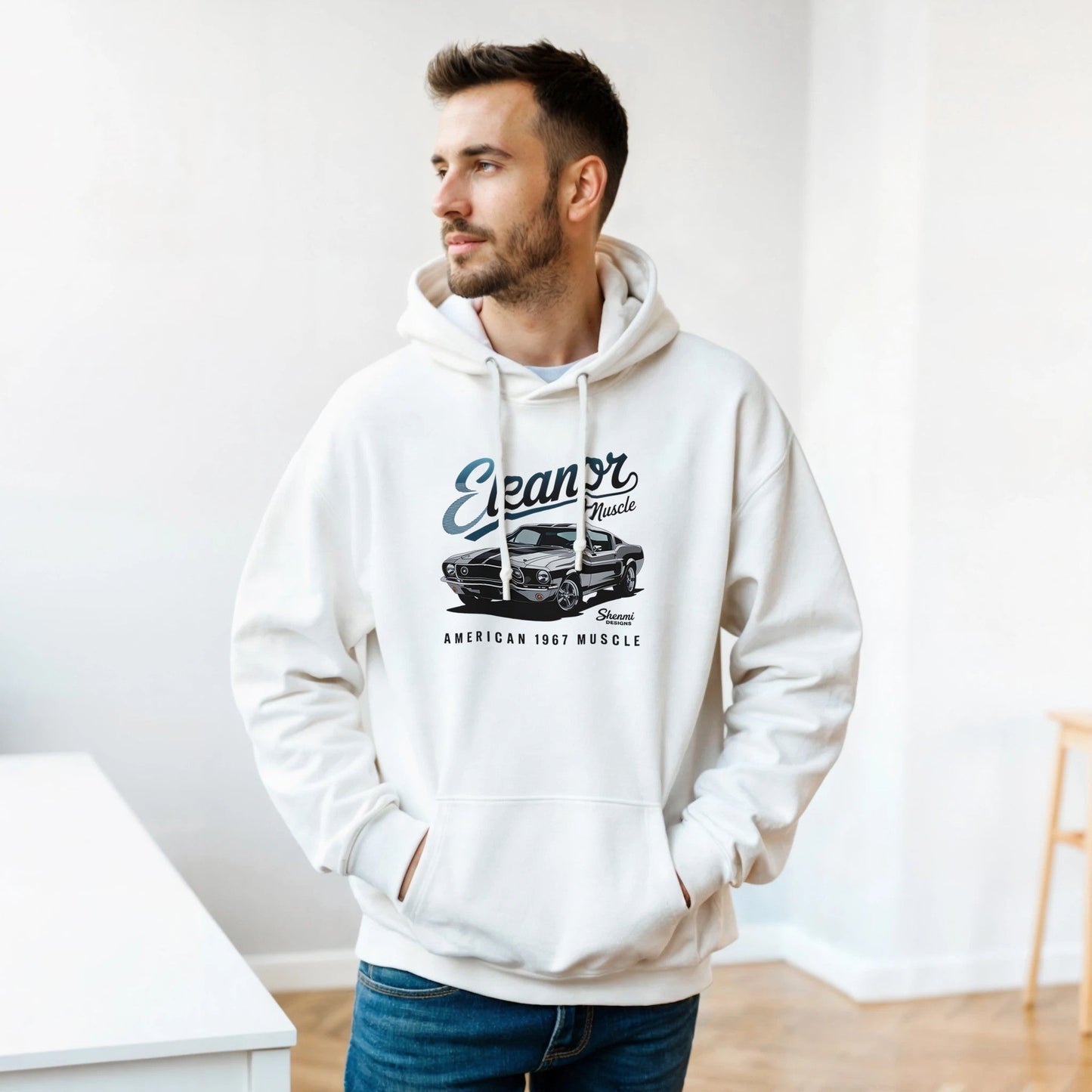 man wearing white eleanor hoodie with muscle car graphic and text "american 1967 muscle" in casual indoor setting