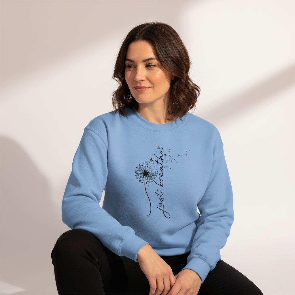 Frau trägt blaues Sweatshirt Entspannungs Pullover aus weicher Baumwollpoly-Mischung mit Dandelion-Design und Schriftzug "Just breathe"