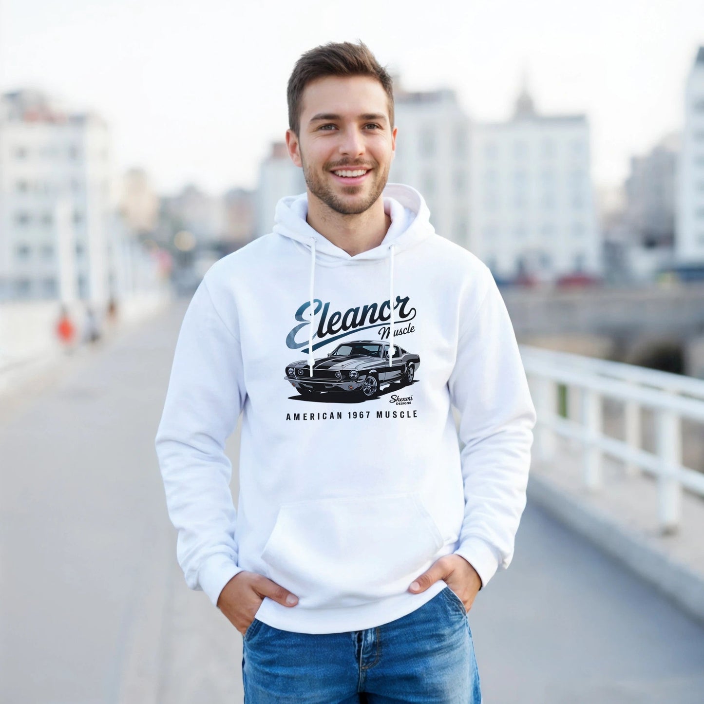 man wearing white eleanor hoodie with muscle car graphic and "american 1967 muscle" text, outdoors on urban street